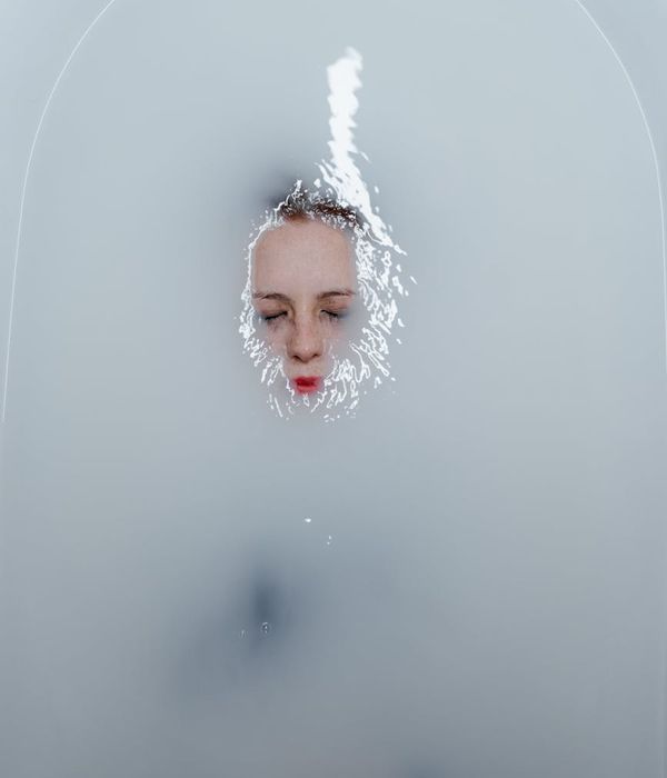 Person meditating peacefully with a serene expression.