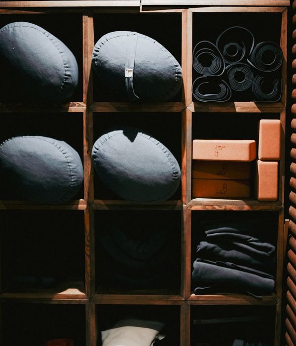 Various yoga props like blocks, straps, and blankets neatly arranged.