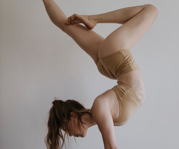 Woman performing a precise yoga pose in a calm studio environment.
